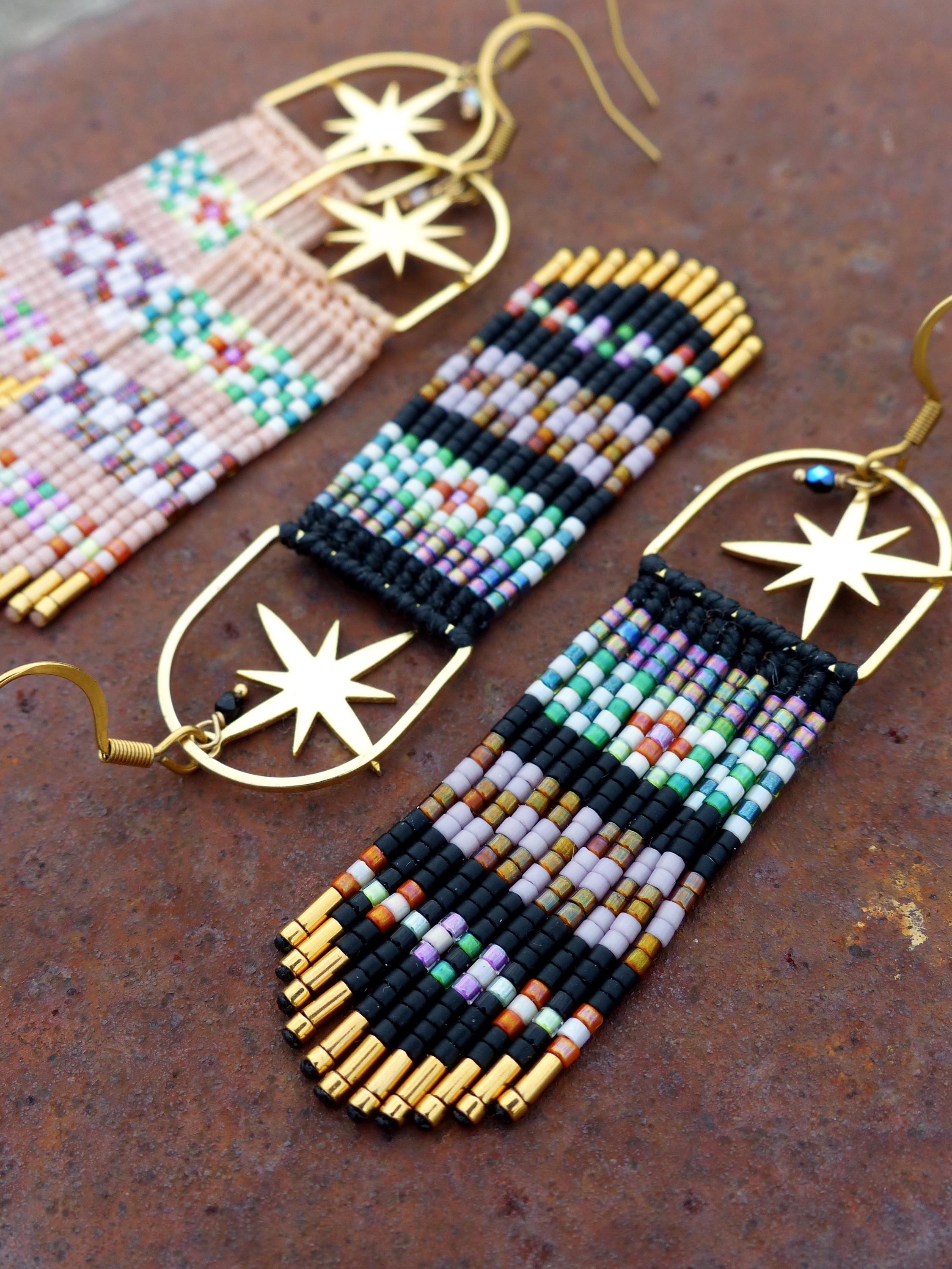 Peut inclure: Une paire de longues boucles d'oreilles en perles avec des breloques en forme d'étoile dorée. Les boucles d'oreilles sont faites de perles noires, blanches et roses, et ont un design en forme de frange.